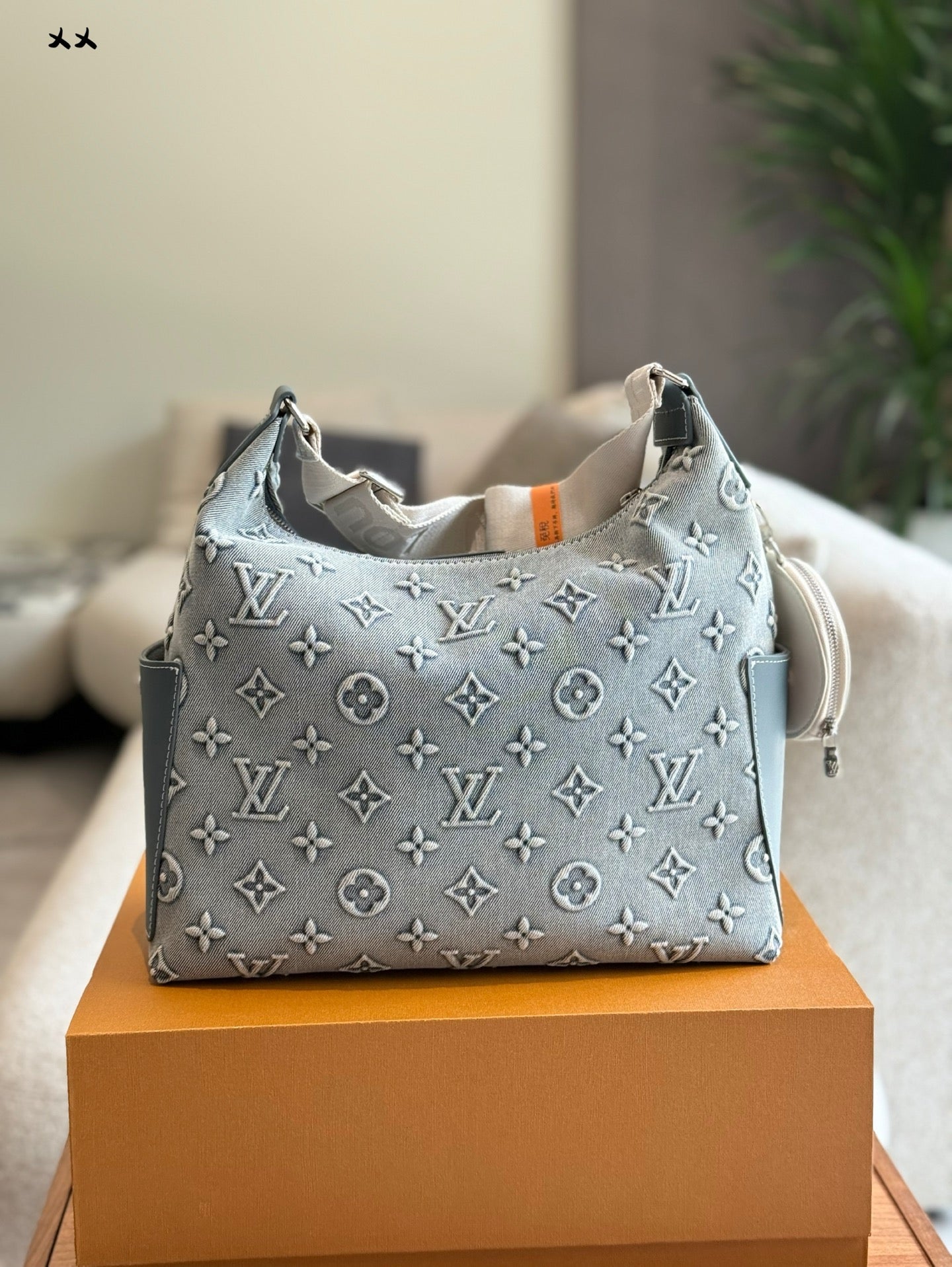 Embossed denim pocket messenger bag