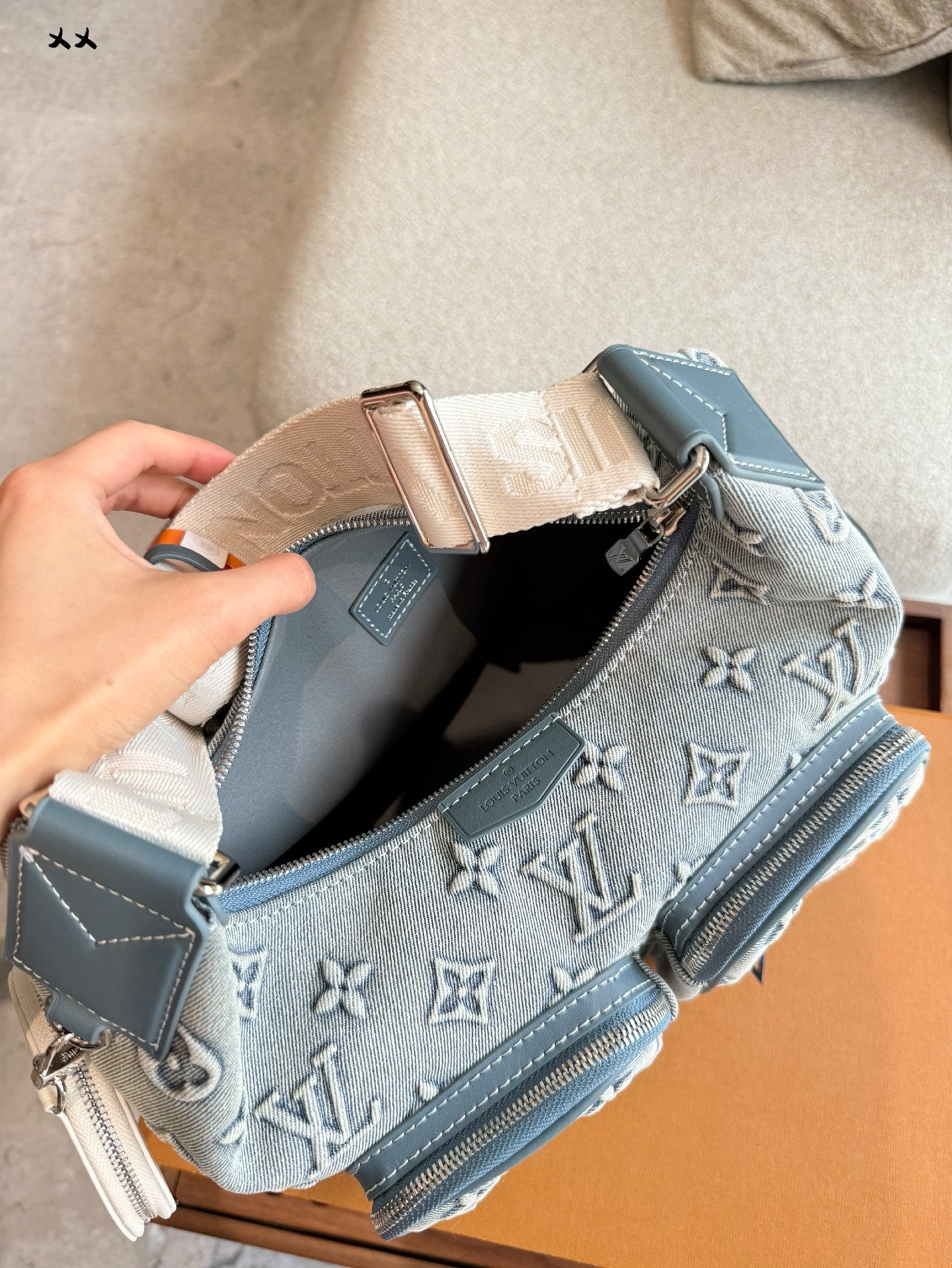 Embossed denim pocket messenger bag