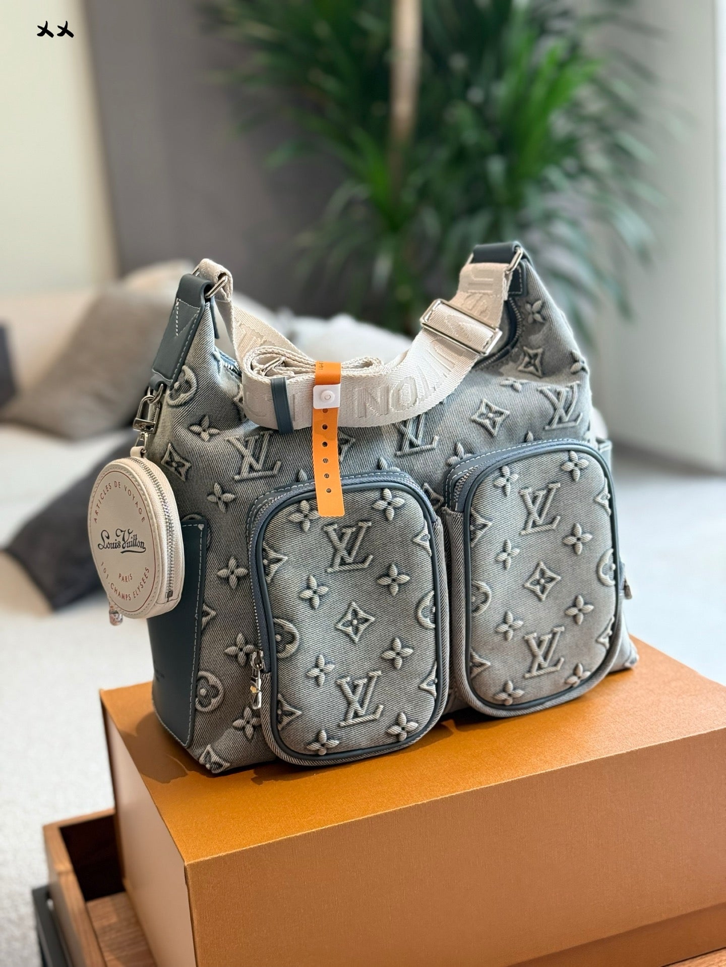 Embossed denim pocket messenger bag