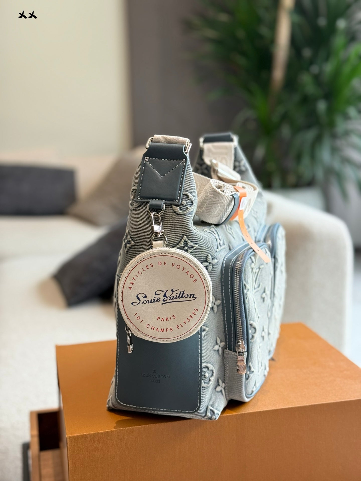 Embossed denim pocket messenger bag