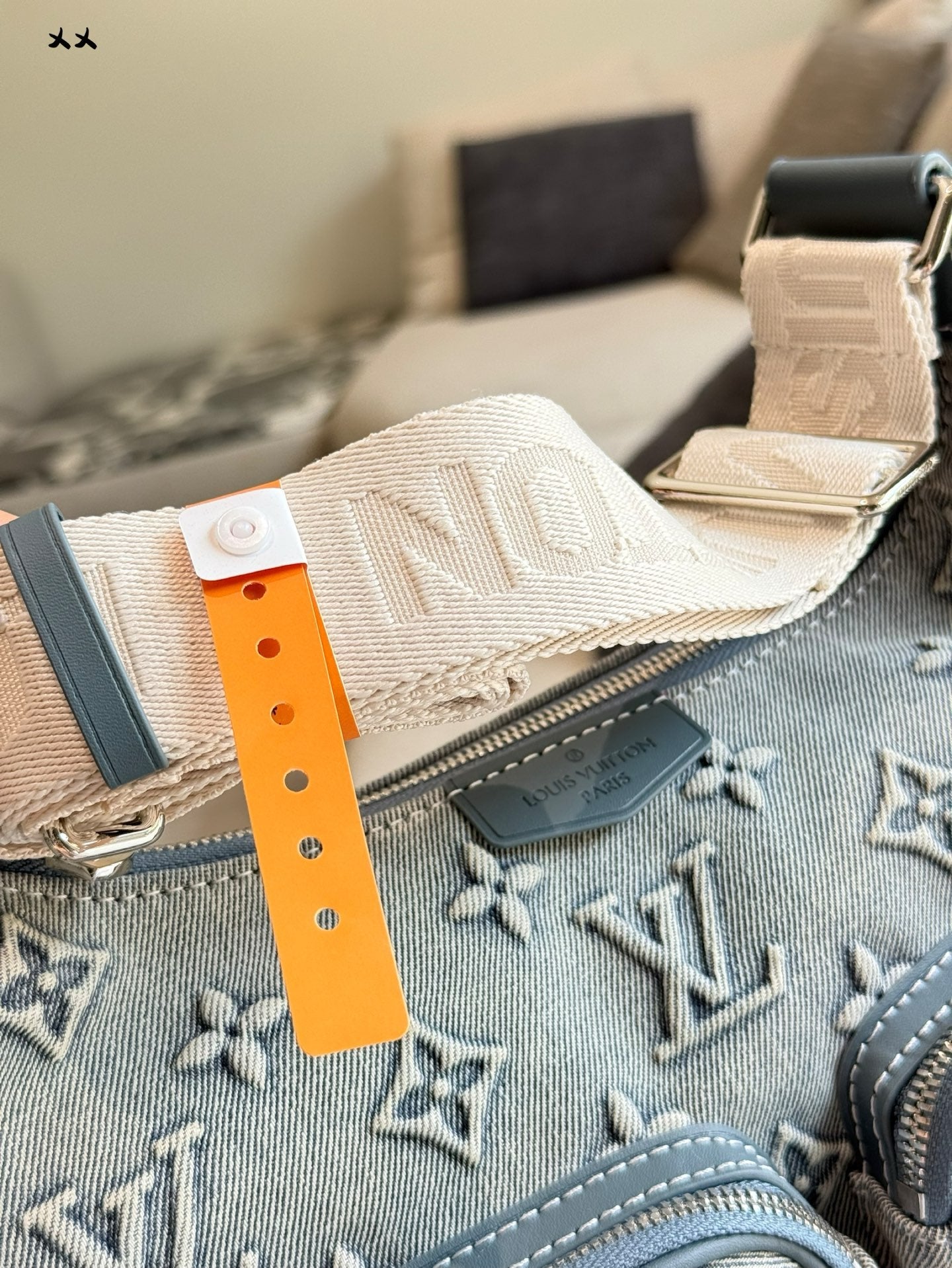 Embossed denim pocket messenger bag