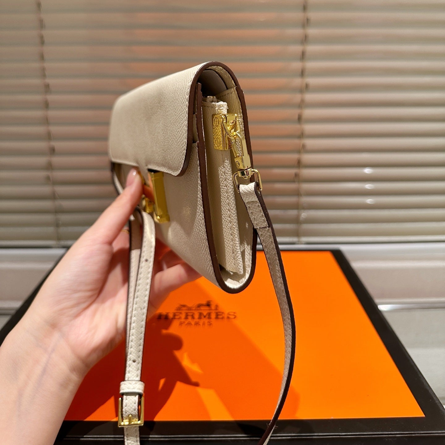 Gold buckle messenger bag