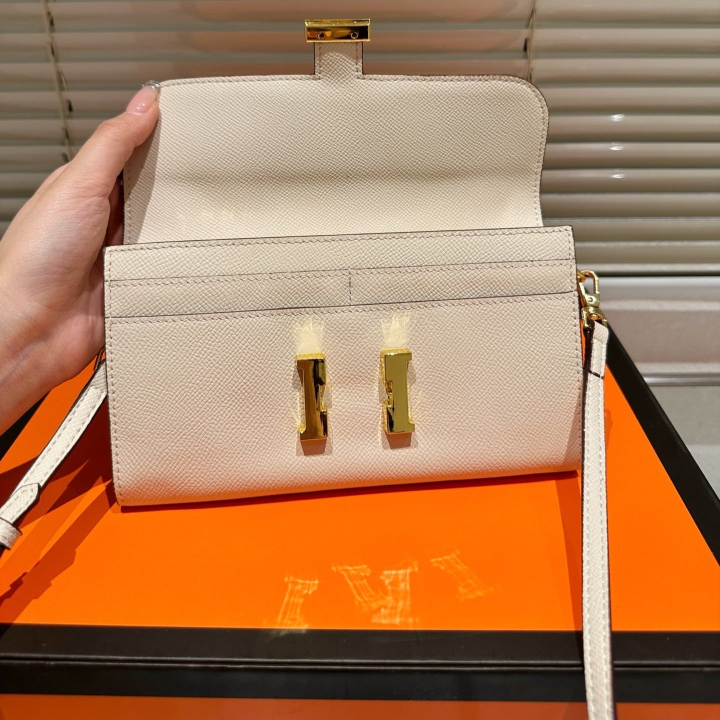 Gold buckle messenger bag