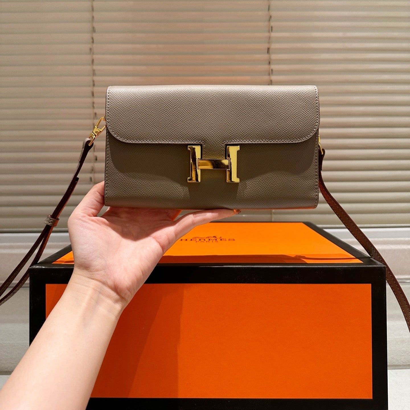 Gold buckle messenger bag