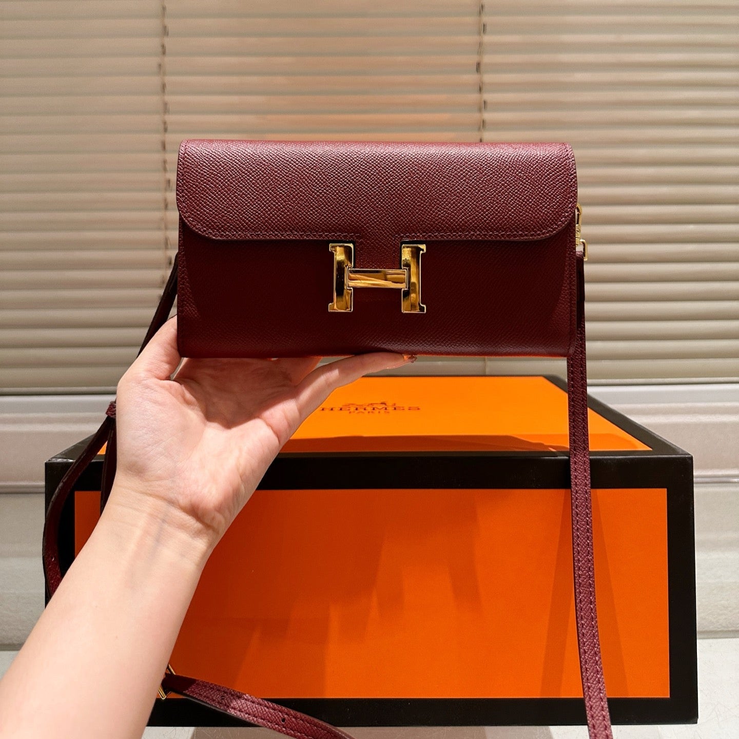 Gold buckle messenger bag