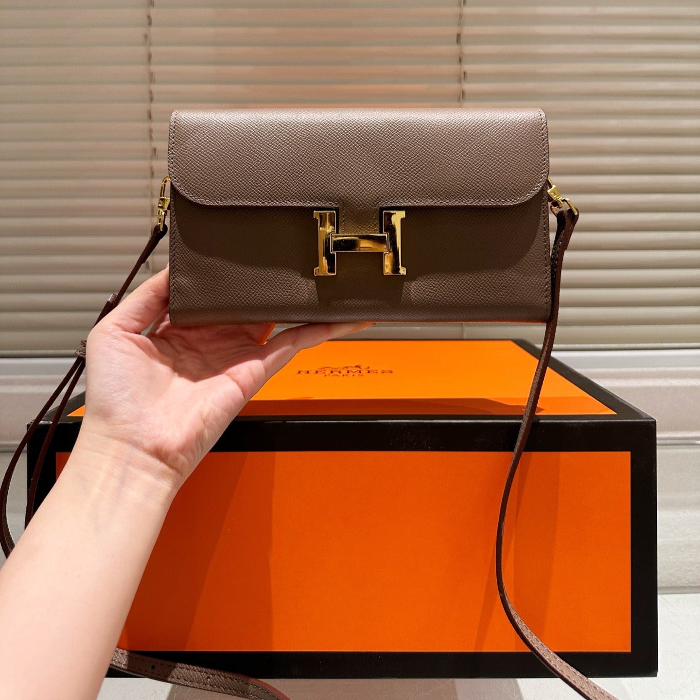 Gold buckle messenger bag