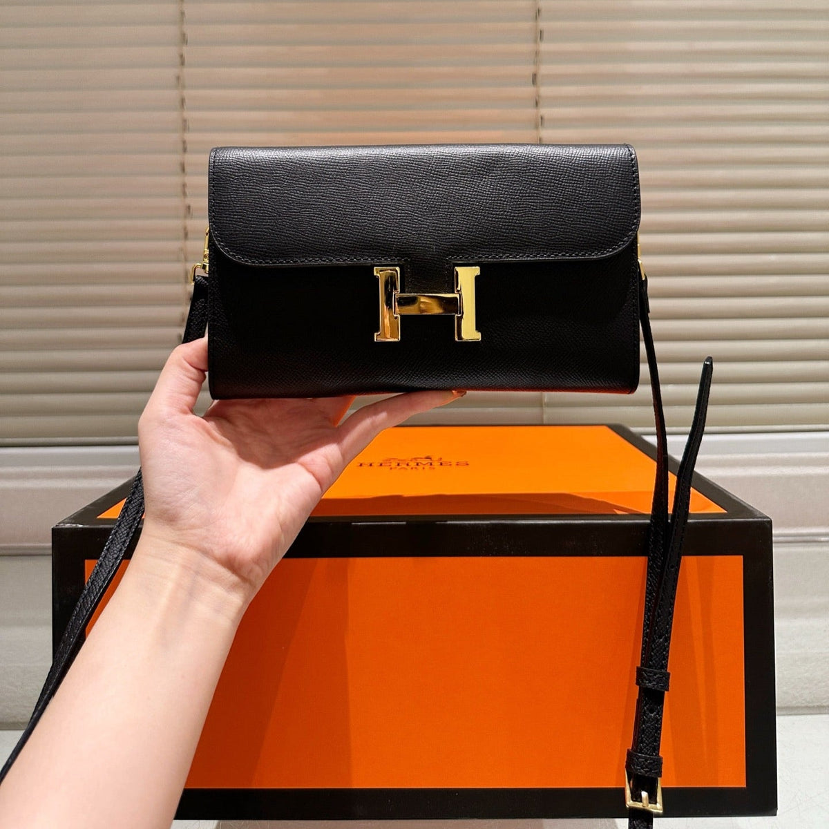Gold buckle messenger bag