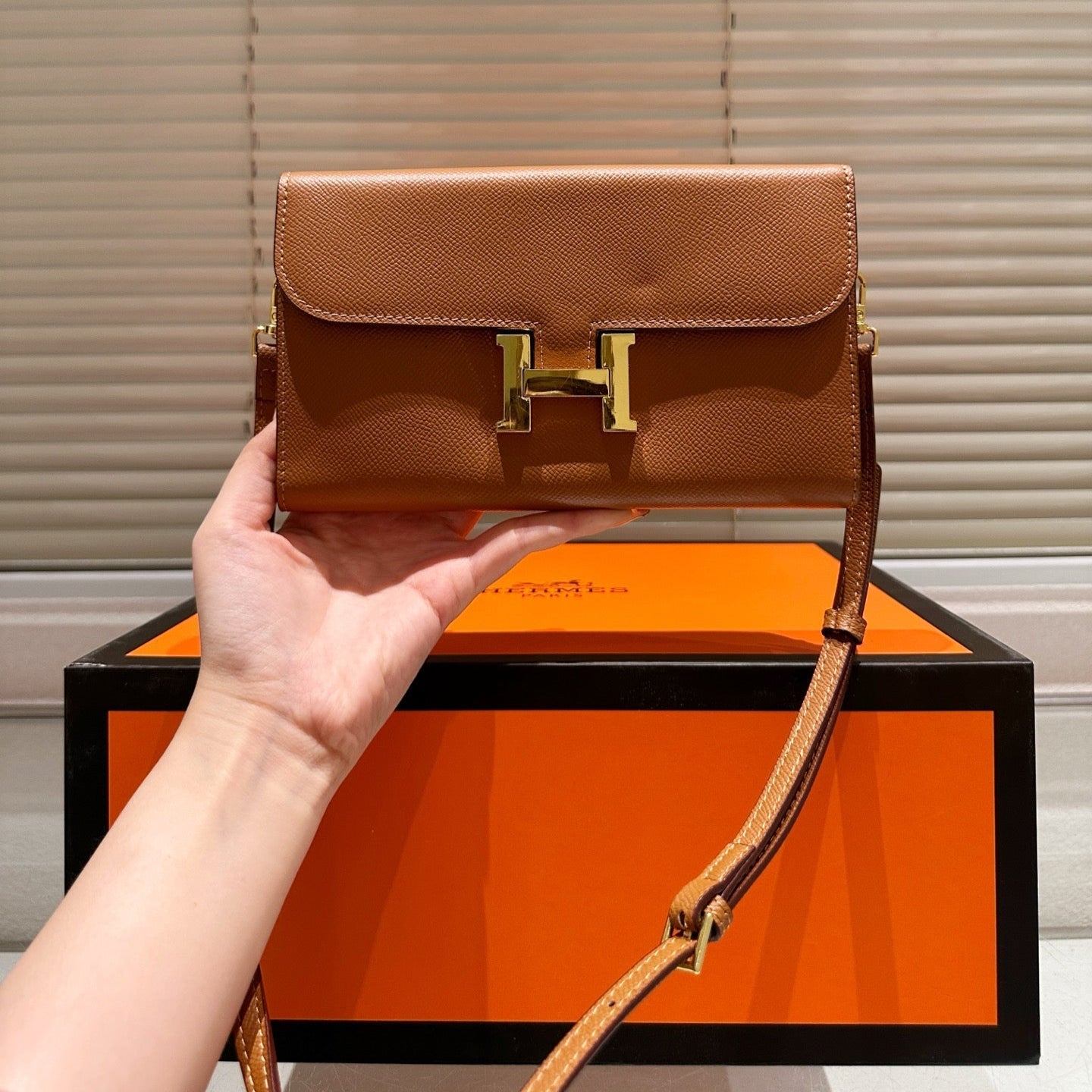 Gold buckle messenger bag